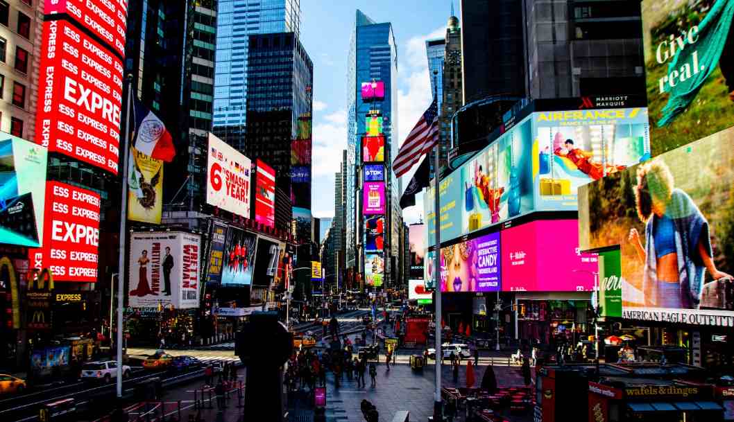 Imagine a giant screen lighting up the night with neon billboards and an unstoppable high-energy buzz—which legendary spot is this?