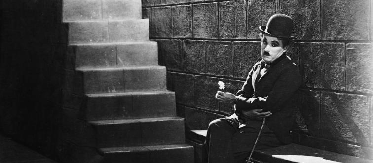 Freeze-frame on the silent era! Which legendary comic became a global icon by waddling onto the screen as “the tramp”?