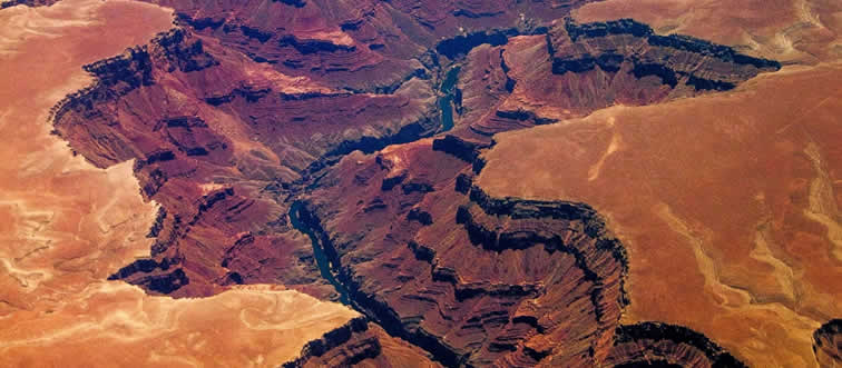Picture a massive, sun-drenched gorge carved right into the earth — which state hosts this giant canyon?