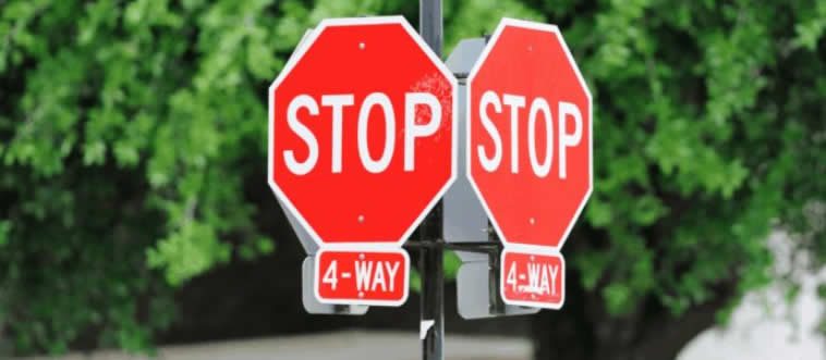 Picture a classic four-panel crossroads where everyone hits the brakes at once. Who gets to roll first?